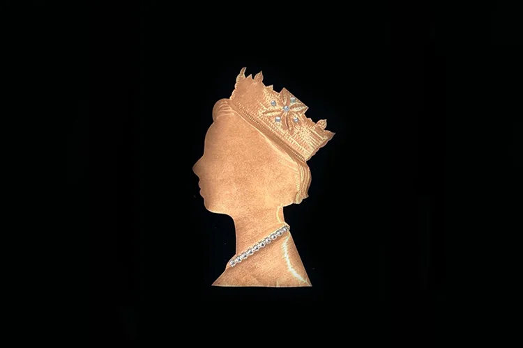Copper toned silhouette profile of Queen Elizabeth II with crown